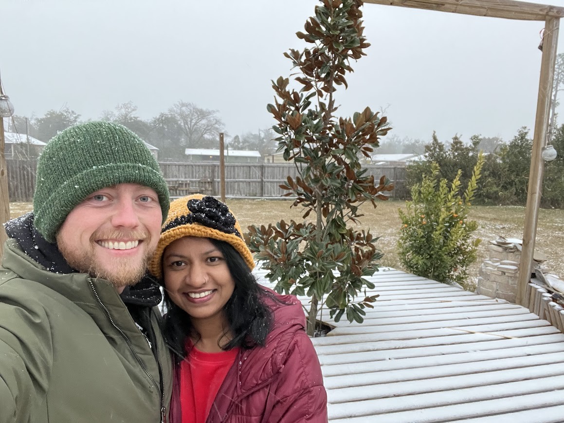 Adam and Fahmida smiling together on a snowy day